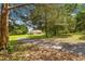 Single-Gathering home surrounded by mature trees, with a winding driveway leading to the property at 5445 Ne Anthony Rd, Ocala, FL 34475