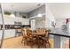 This eat-in kitchen features tile flooring, white cabinets, granite countertops, and stainless steel appliances at 5445 Ne Anthony Rd, Ocala, FL 34475