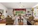 This open living room features hardwood floors, large windows, and three sofas with decorative pillows at 5445 Ne Anthony Rd, Ocala, FL 34475