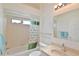 Cozy bathroom featuring a shower-tub combo with a shower curtain and a vanity at 5551 Nw 25Th Loop, Ocala, FL 34482