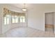 Bright dining area featuring tile floors, decorative lighting, and a large bay window at 5551 Nw 25Th Loop, Ocala, FL 34482