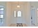 Inviting entryway with decorative front door, tiled floors and elegant lighting fixture at 5551 Nw 25Th Loop, Ocala, FL 34482