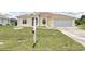 Charming home featuring a well-maintained lawn, inviting curb appeal, and an attached two-car garage at 5551 Nw 25Th Loop, Ocala, FL 34482