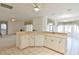 Well-lit kitchen featuring tiled floors, bar seating, and an open view of the dining and living areas at 5551 Nw 25Th Loop, Ocala, FL 34482