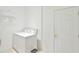 Convenient laundry room includes a washer and dryer, shelf, and utility sink at 5551 Nw 25Th Loop, Ocala, FL 34482