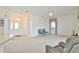 Spacious living room featuring neutral carpeting, ceiling fan, and a view of the entryway at 5551 Nw 25Th Loop, Ocala, FL 34482