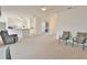 Bright and open floor plan with neutral carpet and easy access to the kitchen and dining areas at 5551 Nw 25Th Loop, Ocala, FL 34482