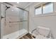 Bathroom featuring a walk-in shower with marbled wall surround, safety bar, and comfort-height toilet at 616 Se 40Th Ave, Ocala, FL 34471
