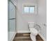 Bathroom featuring a comfort-height toilet and a window for natural lighting at 616 Se 40Th Ave, Ocala, FL 34471