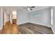 Spacious bedroom with wood flooring, ceiling fan, and natural light from the windows at 616 Se 40Th Ave, Ocala, FL 34471