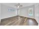 Bedroom featuring wood flooring, ceiling fan, and natural light from the windows at 616 Se 40Th Ave, Ocala, FL 34471