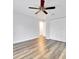 Bedroom features neutral walls, wood-look flooring, ceiling fan, and sliding closet doors at 616 Se 40Th Ave, Ocala, FL 34471