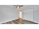 Open bedroom with wood flooring, ceiling fan, and a closet with white doors at 616 Se 40Th Ave, Ocala, FL 34471