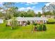 Charming one-story home with a well-manicured lawn, mature trees and tasteful landscaping at 616 Se 40Th Ave, Ocala, FL 34471