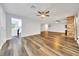 Large living room with brick fireplace, wood floors, and an opening to the kitchen at 616 Se 40Th Ave, Ocala, FL 34471