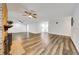 Large living room with brick fireplace, ceiling fan, and wood-look floors at 616 Se 40Th Ave, Ocala, FL 34471