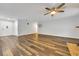 Open living room featuring wood floors, a white front door, and an ornate clock on the wall at 616 Se 40Th Ave, Ocala, FL 34471
