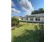 Spacious backyard with lush green grass and partial pergola at 6241 Sw 84Th Pl, Ocala, FL 34476