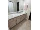 Updated bathroom featuring a marble countertop, cabinetry, and neutral tile flooring at 6241 Sw 84Th Pl, Ocala, FL 34476