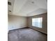 Bedroom featuring neutral colored carpet, tray ceilings and large windows for lots of light at 6241 Sw 84Th Pl, Ocala, FL 34476
