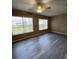 Bedroom featuring updated gray vinyl flooring, a ceiling fan, and natural light at 6241 Sw 84Th Pl, Ocala, FL 34476