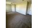 Bedroom featuring neutral decor, carpet flooring, and large closet space, offering a comfortable retreat at 6241 Sw 84Th Pl, Ocala, FL 34476