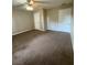 Bedroom featuring carpet flooring, neutral walls, and ample closet space, perfect for relaxation at 6241 Sw 84Th Pl, Ocala, FL 34476