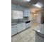 Updated kitchen features granite countertops, white cabinets and stainless steel dishwasher at 6241 Sw 84Th Pl, Ocala, FL 34476