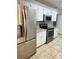 Bright kitchen with stainless steel appliances, granite countertops, and white cabinetry at 6241 Sw 84Th Pl, Ocala, FL 34476