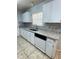 Traditional kitchen with granite countertops, subway tile backsplash, and white cabinets at 6241 Sw 84Th Pl, Ocala, FL 34476