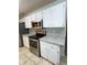 Updated kitchen with white cabinets, stainless steel appliances, and granite countertops at 6241 Sw 84Th Pl, Ocala, FL 34476
