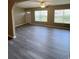 Bright, open living room with newly installed gray vinyl floors and a ceiling fan at 6241 Sw 84Th Pl, Ocala, FL 34476