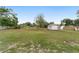 Spacious backyard with a storage shed, mature trees, and partial fencing at 6320 Se 42Nd Ct, Ocala, FL 34480