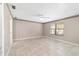 Spacious bedroom featuring tile floors with a large window and decorative ceiling border at 6320 Se 42Nd Ct, Ocala, FL 34480