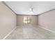 Spacious bedroom with decorative ceiling border, tile flooring and lots of light at 6320 Se 42Nd Ct, Ocala, FL 34480