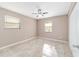 Neutral bedroom featuring tile floors, dual windows, and ceiling fan at 6320 Se 42Nd Ct, Ocala, FL 34480