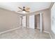 Well-lit bedroom featuring a ceiling fan and spacious closet for ample storage at 6320 Se 42Nd Ct, Ocala, FL 34480