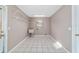 Functional laundry room with a utility sink, tile floors, and convenient wire shelving for storage at 6320 Se 42Nd Ct, Ocala, FL 34480
