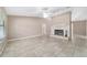 Bright living room with a stone fireplace, a ceiling fan, and tile floors at 6320 Se 42Nd Ct, Ocala, FL 34480