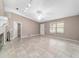 Open living room with ceiling fan, neutral walls, tile flooring, and natural light at 6320 Se 42Nd Ct, Ocala, FL 34480