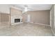 Bright living room with a stone fireplace, a ceiling fan, and tile floors at 6320 Se 42Nd Ct, Ocala, FL 34480