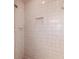 Shower stall featuring light tile with a built-in shampoo niche at 6320 Se 42Nd Ct, Ocala, FL 34480