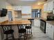 Cozy eat-in kitchen features stainless steel appliances, white cabinetry, and bar seating at 741 Truman Ave, Lady Lake, FL 32159