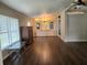 Open living room features wood-look floors and updated chandelier with built in storage at 741 Truman Ave, Lady Lake, FL 32159