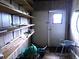 Shed with wood paneling, shelving, a window for natural light, and space for tools and storage at 741 Truman Ave, Lady Lake, FL 32159