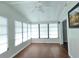 Bright sun room with lots of windows, ceiling fan, and wood-look floors at 741 Truman Ave, Lady Lake, FL 32159