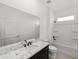 Bright bathroom featuring white cabinetry, tub and shower combo, and granite countertops at 7513 Sw 56Th Pl, Ocala, FL 34474