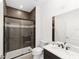 Modern bathroom features a glass enclosed shower, white marble counters and dark cabinets at 7513 Sw 56Th Pl, Ocala, FL 34474