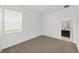 Neutral carpeted bedroom with a window and view to the en-suite bathroom at 7513 Sw 56Th Pl, Ocala, FL 34474