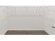 Spacious walk-in closet includes neutral carpeting, base trim, and white wire shelving at 7513 Sw 56Th Pl, Ocala, FL 34474